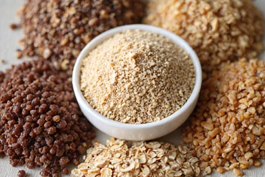 A close-up of a variety of whole grains such as quinoa, brown rice, and oats, emphasizing their role in a healthy diet.